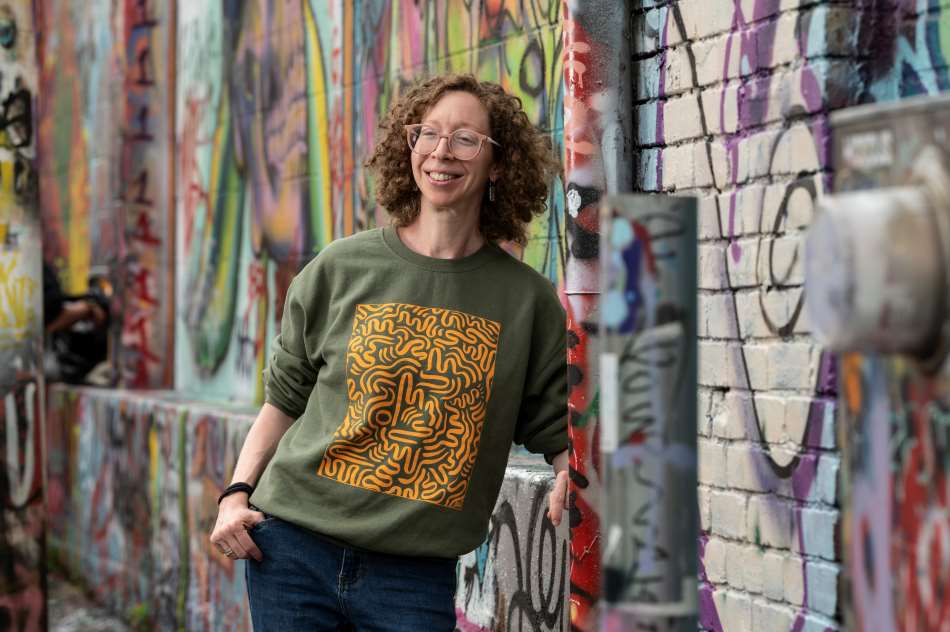 Bruce leaning against graffiti covered wall